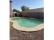 Backyard pool with stone border offers refreshing outdoor oasis, surrounded by privacy fence at 284 W Settlers Trl, Casa Grande, AZ 85122