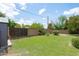 Backyard featuring a lush lawn, a shed, and a wrought iron gate at 2913 E Earll Dr, Phoenix, AZ 85016