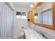 Bathroom featuring a vanity with marble countertop, wooden cabinets, toilet, and window at 2913 E Earll Dr, Phoenix, AZ 85016