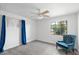 Bright bedroom with a ceiling fan, a window with view and a velvet chair at 2913 E Earll Dr, Phoenix, AZ 85016