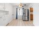 Bright kitchen area with stainless steel refrigerator and white cabinetry at 2913 E Earll Dr, Phoenix, AZ 85016
