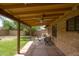 Covered outdoor patio featuring a ceiling fan and a dining set, perfect for entertaining and enjoying the backyard view at 2913 E Earll Dr, Phoenix, AZ 85016