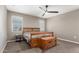 Cozy bedroom with wood furniture, a ceiling fan, and natural light from two windows at 37008 N Hinterwald Way, San Tan Valley, AZ 85143