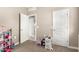 Neutral-colored bedroom with a closet, an open doorway, and a play area in the corner of the room at 37008 N Hinterwald Way, San Tan Valley, AZ 85143