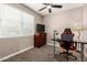 Comfortable bedroom includes neutral walls, carpeted floors, a ceiling fan, and an adjustable height desk at 37008 N Hinterwald Way, San Tan Valley, AZ 85143
