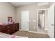 Bedroom featuring neutral paint, a view into another room, and a dark wood dresser with drawers at 37008 N Hinterwald Way, San Tan Valley, AZ 85143