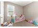Bright bedroom with a large window and built-in shelving units filled with organized toys and storage bins at 37008 N Hinterwald Way, San Tan Valley, AZ 85143