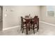 Dining area features tile floors, a window with blinds, and a wooden table with four chairs at 37008 N Hinterwald Way, San Tan Valley, AZ 85143
