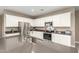 Bright kitchen boasts stainless steel appliances, gray countertops, and white cabinets at 37008 N Hinterwald Way, San Tan Valley, AZ 85143