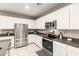 Modern kitchen features stainless steel appliances, white cabinets, and a spacious countertop at 37008 N Hinterwald Way, San Tan Valley, AZ 85143