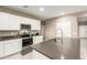 Bright kitchen with white cabinets, gray countertops, and stainless-steel appliances at 37008 N Hinterwald Way, San Tan Valley, AZ 85143