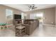 Bright living room with a comfortable sectional sofa, tile floors, and sliding glass door for natural light at 37008 N Hinterwald Way, San Tan Valley, AZ 85143