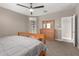 Bedroom featuring natural wood furniture, carpeted floor, and access to the en-suite bathroom at 37008 N Hinterwald Way, San Tan Valley, AZ 85143