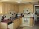 Functional kitchen with wooden cabinets and a standard appliance package at 4107 E Bloomfield Rd, Phoenix, AZ 85032