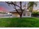 Backyard featuring well-maintained lawn, mature tree, and covered patio at 4205 N 19Th Pl, Phoenix, AZ 85016