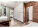 Bathroom featuring wood accent wall, soaking tub, glass shower, and modern vanity at 4205 N 19Th Pl, Phoenix, AZ 85016