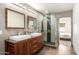 Bathroom featuring double vanity, glass shower, and a view into the bedroom at 4205 N 19Th Pl, Phoenix, AZ 85016