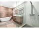 Modern bathroom with wood accent wall, soaking tub, glass shower, and double vanity at 4205 N 19Th Pl, Phoenix, AZ 85016
