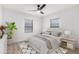 Cozy bedroom with neutral tones, two windows, ceiling fan, wood-look flooring, and a decorative area rug at 4205 N 19Th Pl, Phoenix, AZ 85016