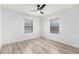 Light-filled bedroom featuring laminate flooring, a ceiling fan, and modern window shades at 4205 N 19Th Pl, Phoenix, AZ 85016