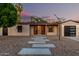 Charming home with desert landscaping, modern front door, and a detached garage at 4205 N 19Th Pl, Phoenix, AZ 85016