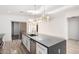 Kitchen with a large island, stylish lighting, stainless appliances, and bright white walls at 4205 N 19Th Pl, Phoenix, AZ 85016