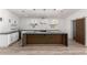 Open kitchen with large island, modern lighting, stainless appliances, and bright subway tile backsplash at 4205 N 19Th Pl, Phoenix, AZ 85016