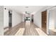 Bright living room featuring an open floor plan, light wood floors, and access to the kitchen at 4205 N 19Th Pl, Phoenix, AZ 85016