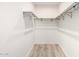 A simple walk-in closet with neutral decor and plenty of storage and space at 4205 N 19Th Pl, Phoenix, AZ 85016