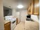 Functional kitchen featuring white appliances, wood cabinets and tile flooring at 4714 E Pueblo Ave, Phoenix, AZ 85040