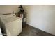Functional laundry area with a top-load washing machine and water heater for added convenience at 4714 E Pueblo Ave, Phoenix, AZ 85040