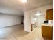 Open living space with neutral tile flooring, connecting the living room and kitchen at 4714 E Pueblo Ave, Phoenix, AZ 85040