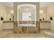 Luxurious bathroom with a soaking tub, dual vanities, and natural stone accents at 5122 S Miller Pl, Chandler, AZ 85249