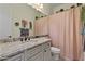 Neutral bathroom with a granite countertop, plants for decor and light pink shower curtain at 5122 S Miller Pl, Chandler, AZ 85249