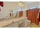 Bathroom with double sinks, granite countertops, and a large vanity mirror at 5122 S Miller Pl, Chandler, AZ 85249