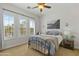 Bedroom with white walls, large windows, and a cozy bed with lots of pillows at 5122 S Miller Pl, Chandler, AZ 85249