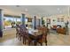 Bright dining room with a wooden table, large windows, and views of the backyard at 5122 S Miller Pl, Chandler, AZ 85249