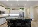 Bright kitchen showcasing white cabinets, a dark island, and stainless steel appliances at 5122 S Miller Pl, Chandler, AZ 85249