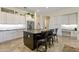 Bright kitchen with white cabinetry, black island, and stainless steel refrigerator at 5122 S Miller Pl, Chandler, AZ 85249