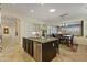 Spacious kitchen with white cabinets, a dark island, and stainless steel dishwasher at 5122 S Miller Pl, Chandler, AZ 85249