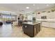 Spacious kitchen featuring white cabinets, a dark island, granite countertops and stainless steel appliances at 5122 S Miller Pl, Chandler, AZ 85249