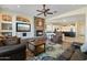 Open concept living room showcasing a stone fireplace, comfortable seating, and views of the kitchen at 5122 S Miller Pl, Chandler, AZ 85249
