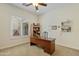 Bright home office with a large window, lots of storage and a ceiling fan at 5122 S Miller Pl, Chandler, AZ 85249