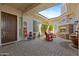 Cozy outdoor patio with a stone fireplace, comfortable rocking chairs, and stylish decor at 5122 S Miller Pl, Chandler, AZ 85249