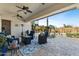 Covered patio with stylish outdoor furniture, ceiling fans, and views of the landscaped backyard at 5122 S Miller Pl, Chandler, AZ 85249