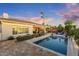 A sparkling swimming pool with lush landscaping and outdoor lounge furniture at 5122 S Miller Pl, Chandler, AZ 85249