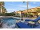 A sparkling swimming pool surrounded by lush landscaping and lounge furniture at 5122 S Miller Pl, Chandler, AZ 85249