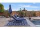 A sparkling swimming pool with lush landscaping and cozy lounge furniture at 5122 S Miller Pl, Chandler, AZ 85249