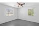 Well-lit bedroom with neutral walls, gray flooring, and natural light from two windows at 541 W Vernon Ave, Phoenix, AZ 85003