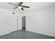 Clean bedroom features a ceiling fan, gray flooring, and neutral walls at 541 W Vernon Ave, Phoenix, AZ 85003